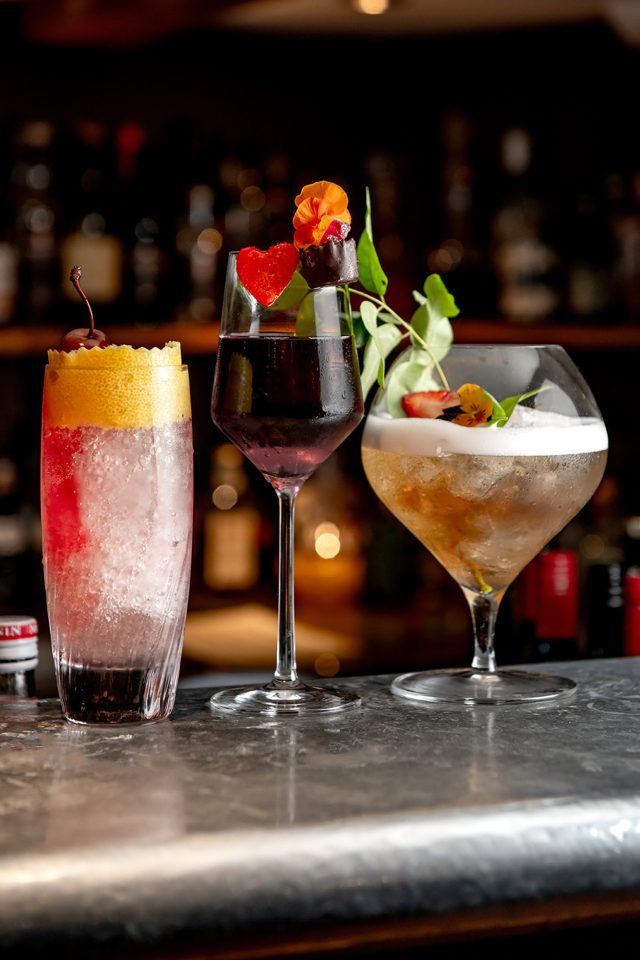 Three vibrant classic cocktails on the bar at Riwaz Indian restaurant in Beaconsfield.